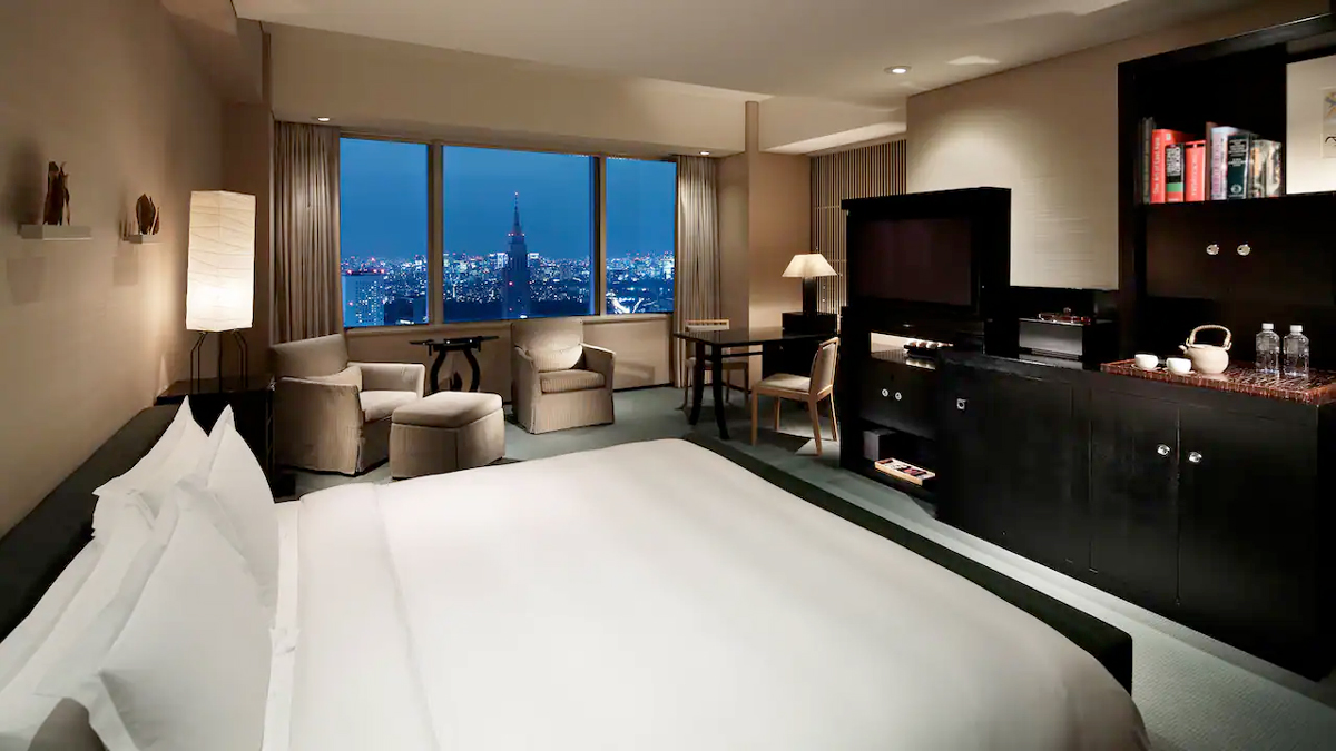 a room with a large bed and a television