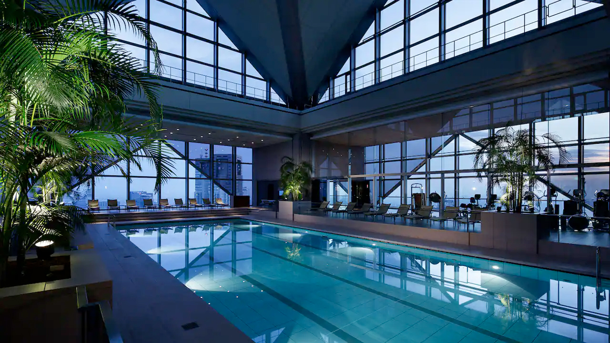 a indoor swimming pool with a large glass wall and a large window