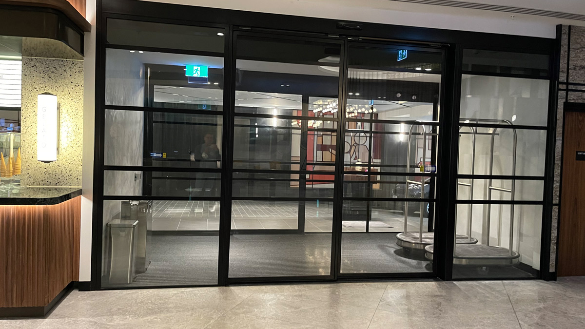 a glass door with a person standing in the middle