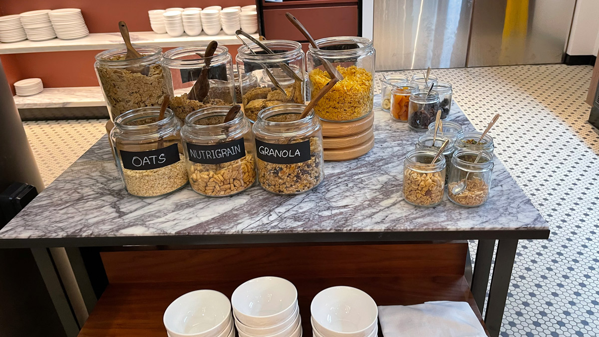 a group of glass jars with different types of cereals