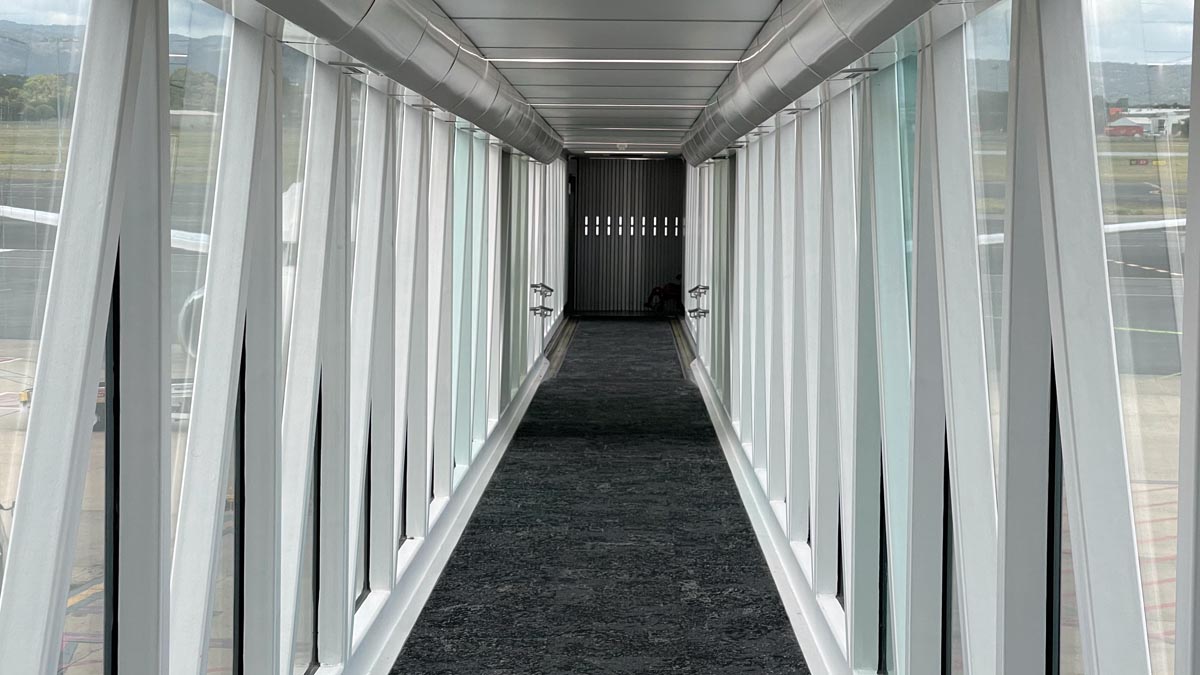 a long hallway with white walls and windows