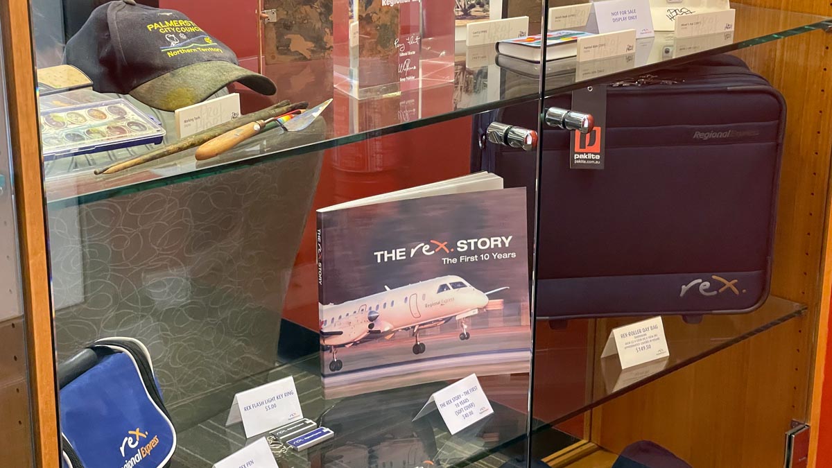 a glass case with a book and other items on it