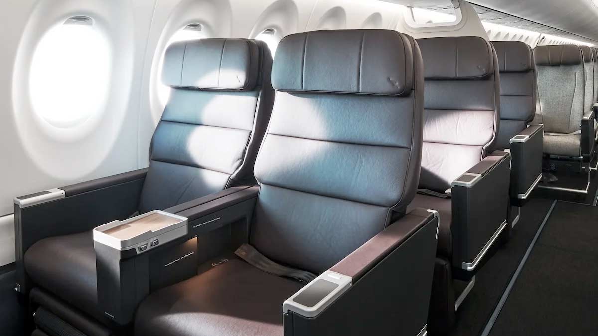 a row of black leather seats in an airplane