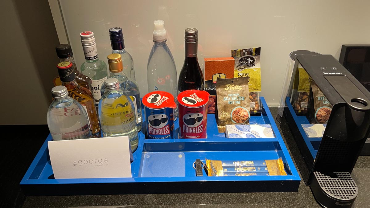 a blue tray with bottles and snacks