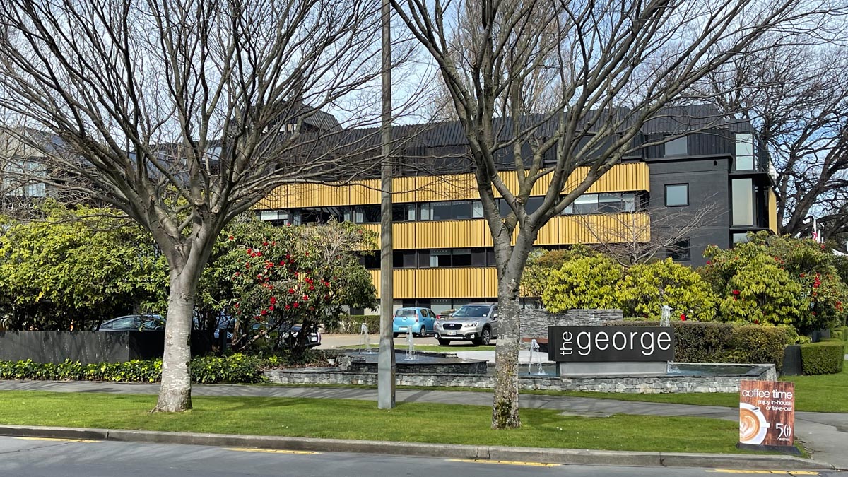 a building with trees and a sign