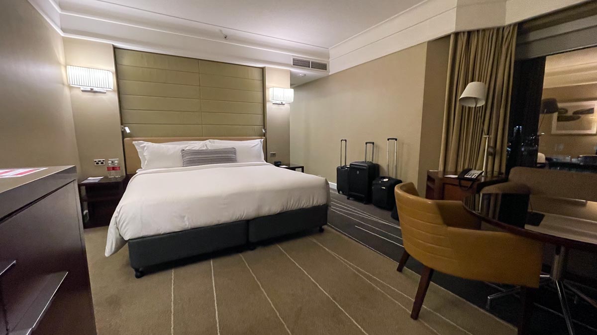 a hotel room with a bed and luggage