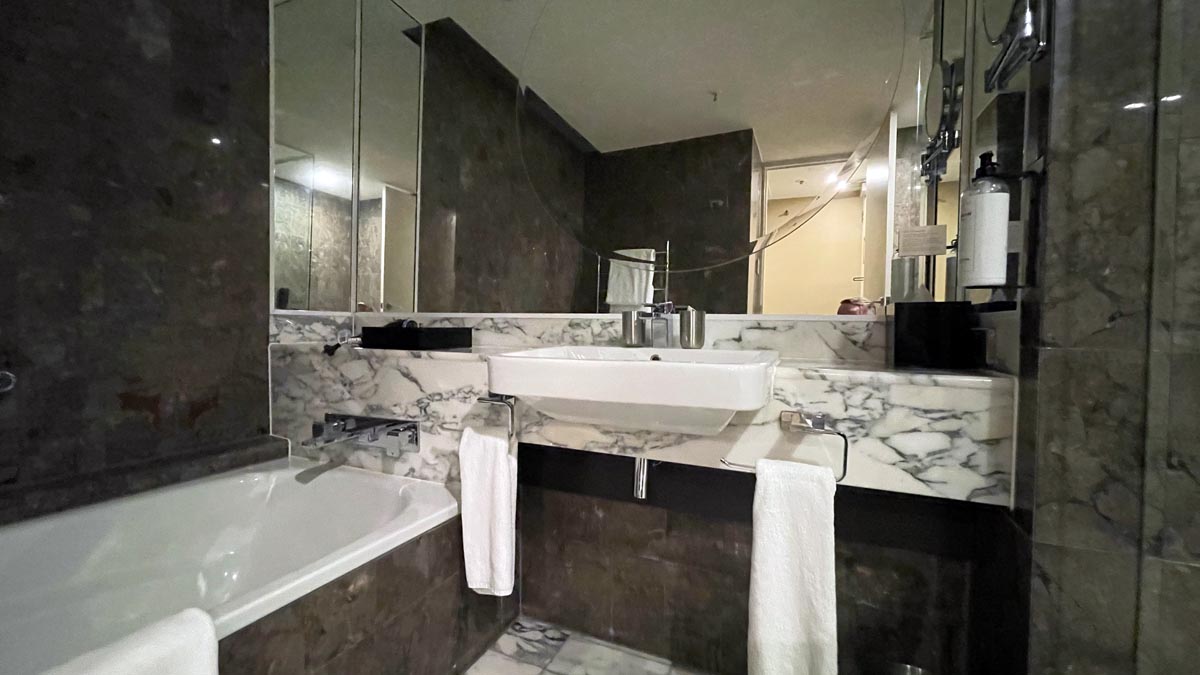 a bathroom with marble countertops and a sink