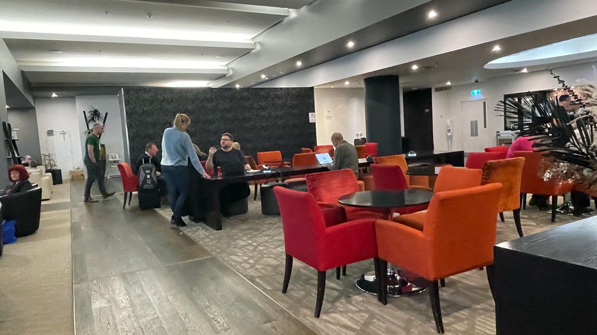 a group of people in a room with chairs and tables