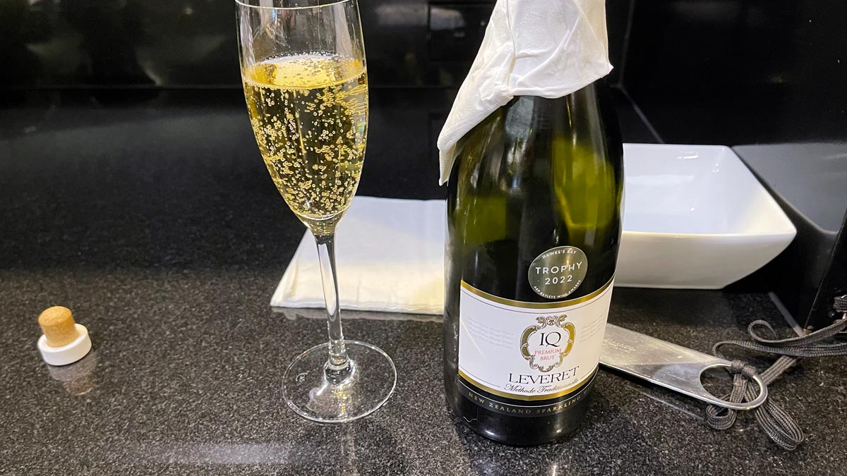 a glass of champagne next to a bottle