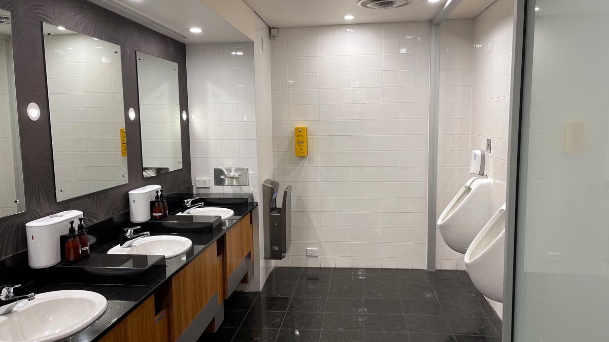 a bathroom with urinals and sinks