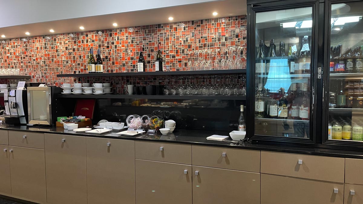 a counter with wine glasses and bowls on it