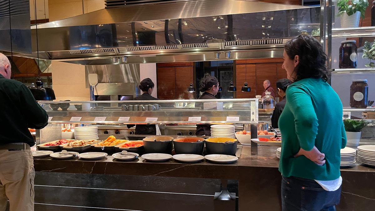 a woman standing in front of a buffet