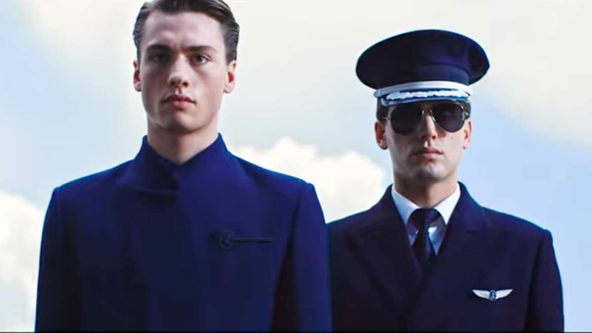 two men in suits and sunglasses