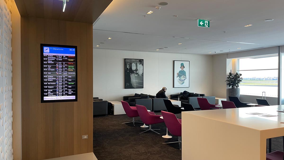 a room with a digital screen and a man sitting in a chair