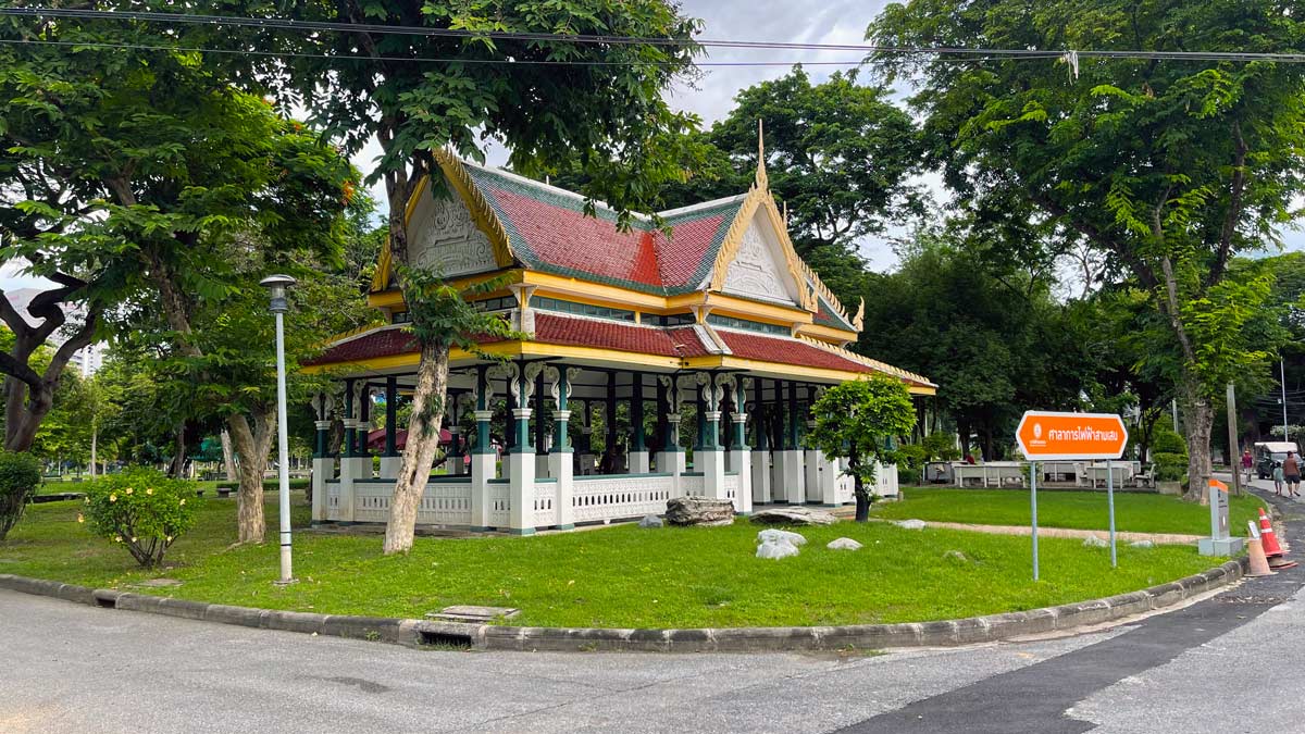 a building with a red roof and a white fence