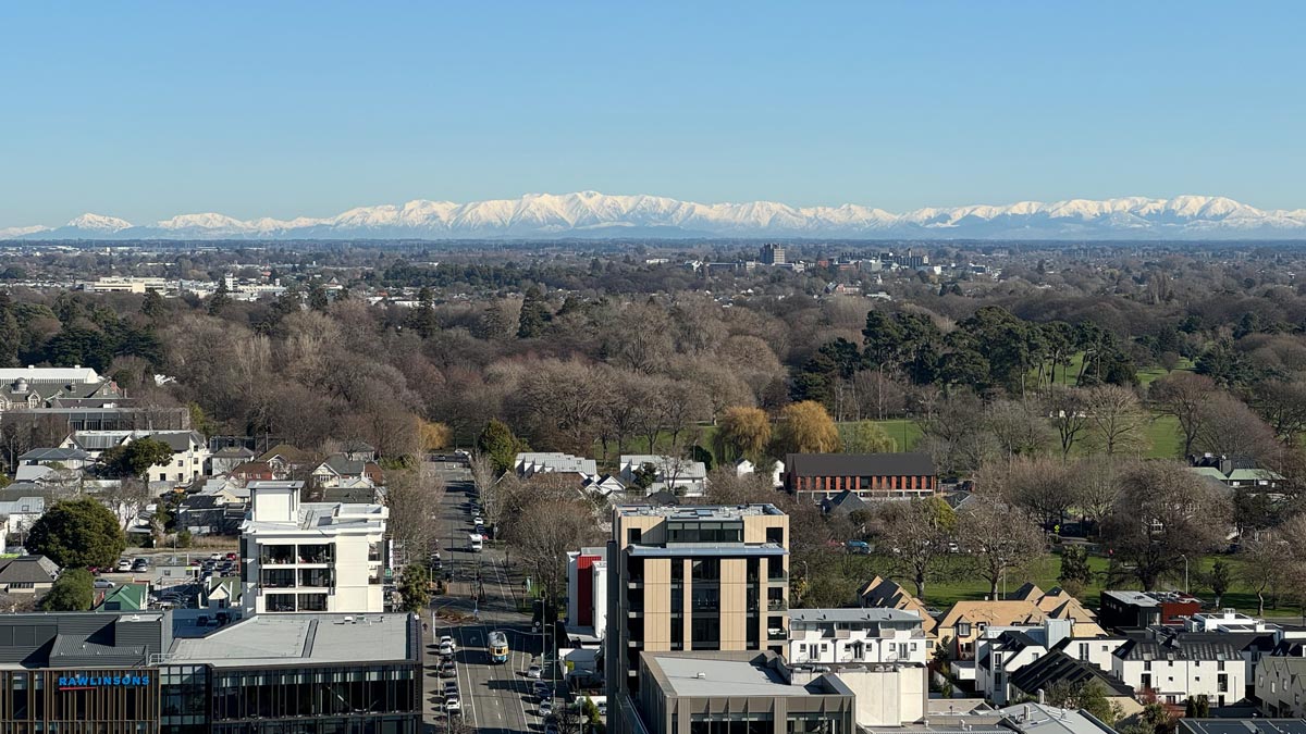 a city with trees and mountains in the background