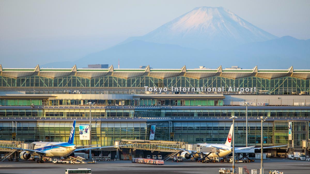 a large building with a mountain in the background