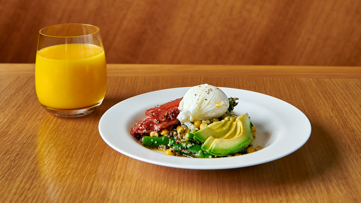 a plate of food and a glass of juice