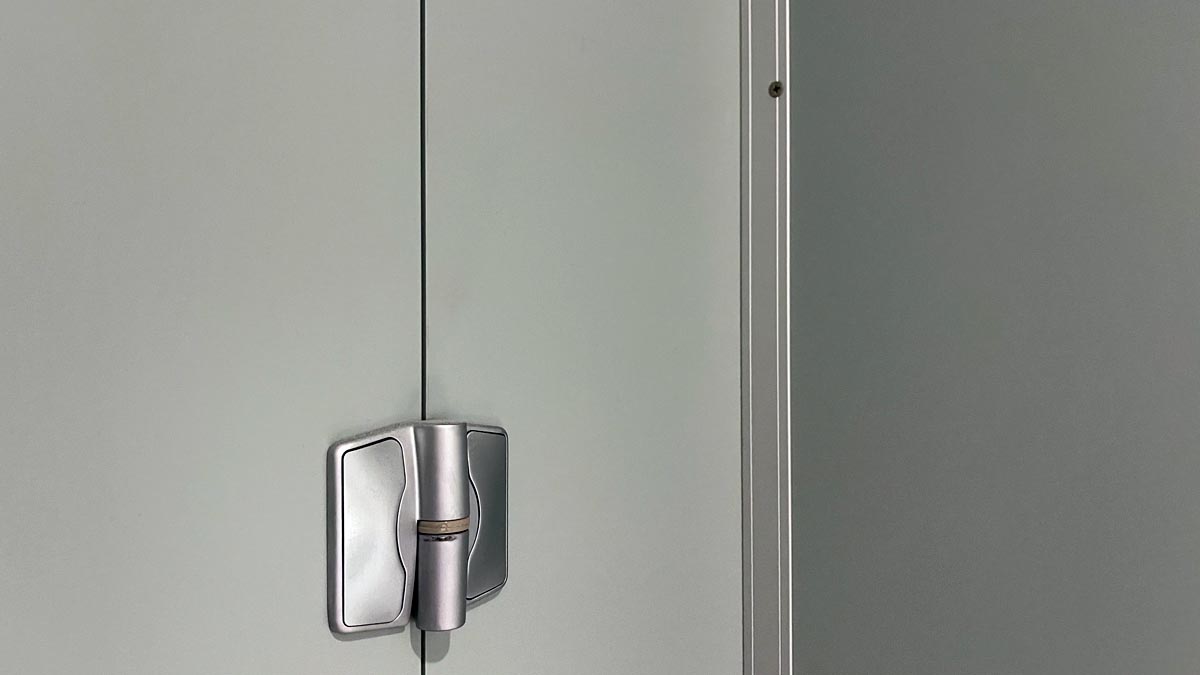 a metal hinge on a white door