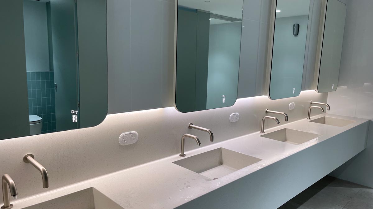 a bathroom with sinks and mirrors