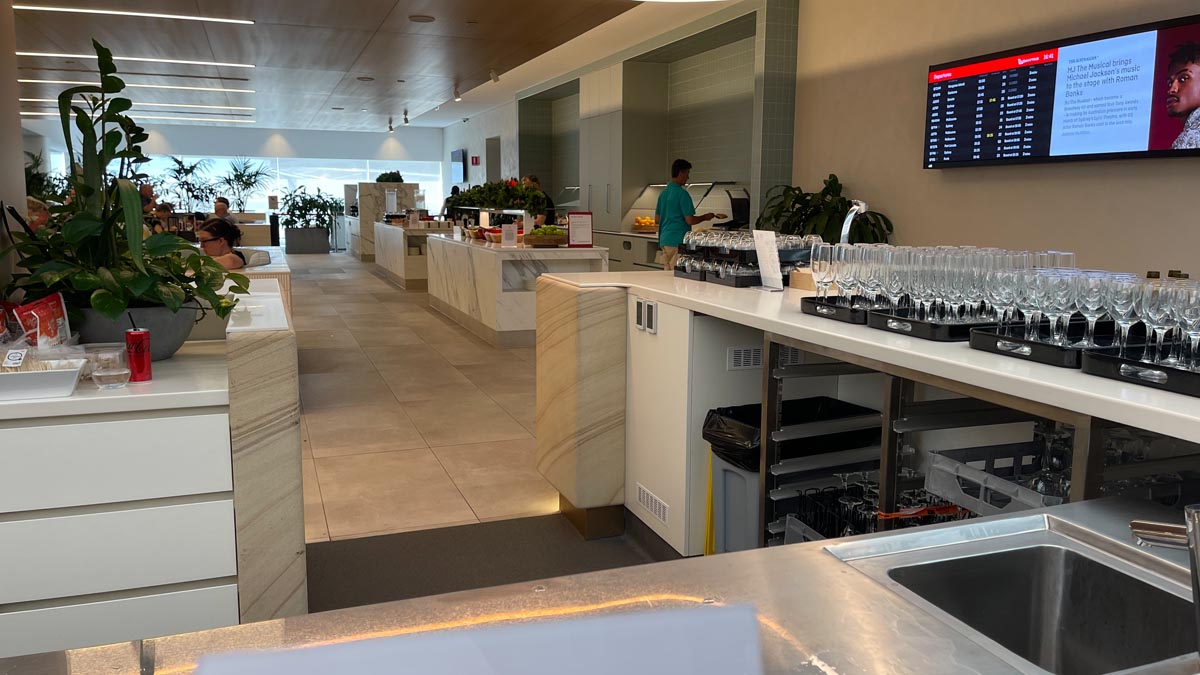 a room with a counter and a man standing in front of it