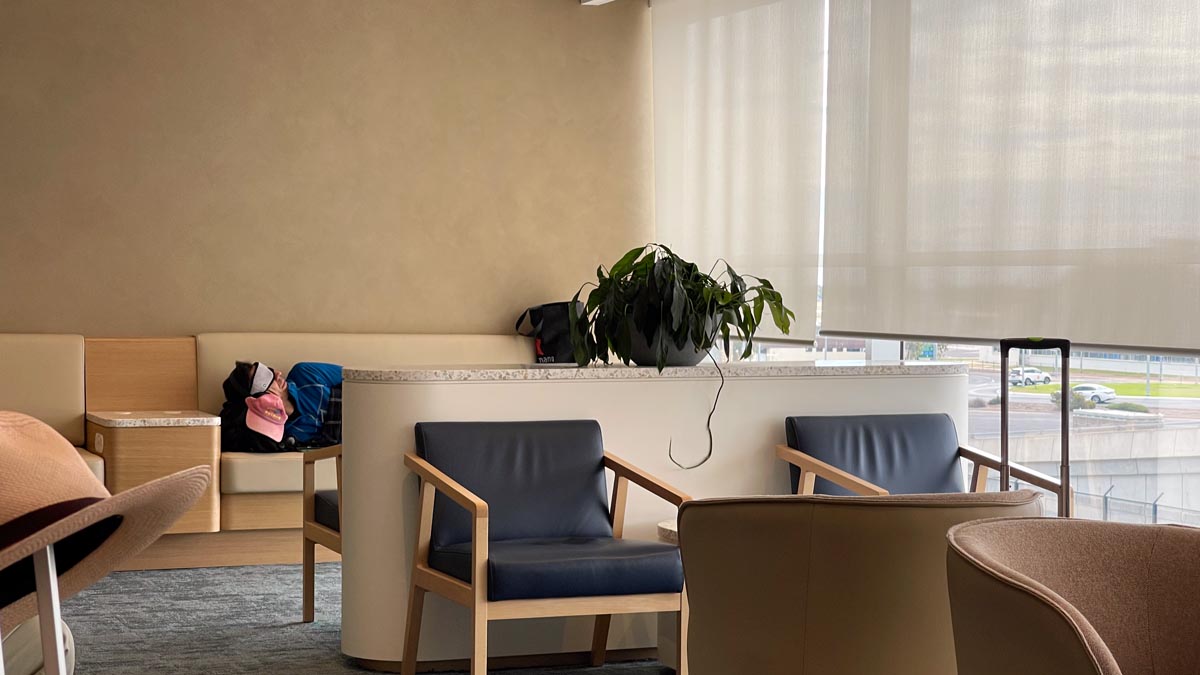 a person lying on a table in a room with chairs