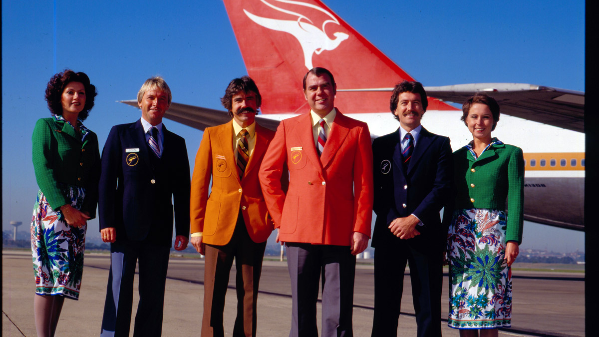 a group of people standing in front of a plane