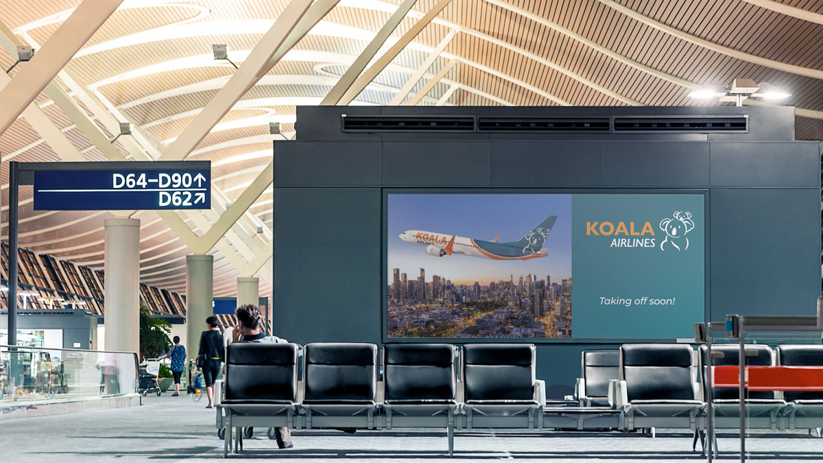 a man sitting in a waiting area with a large screen