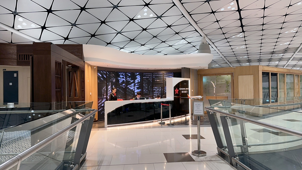 a lobby with a couple of people standing at a reception desk